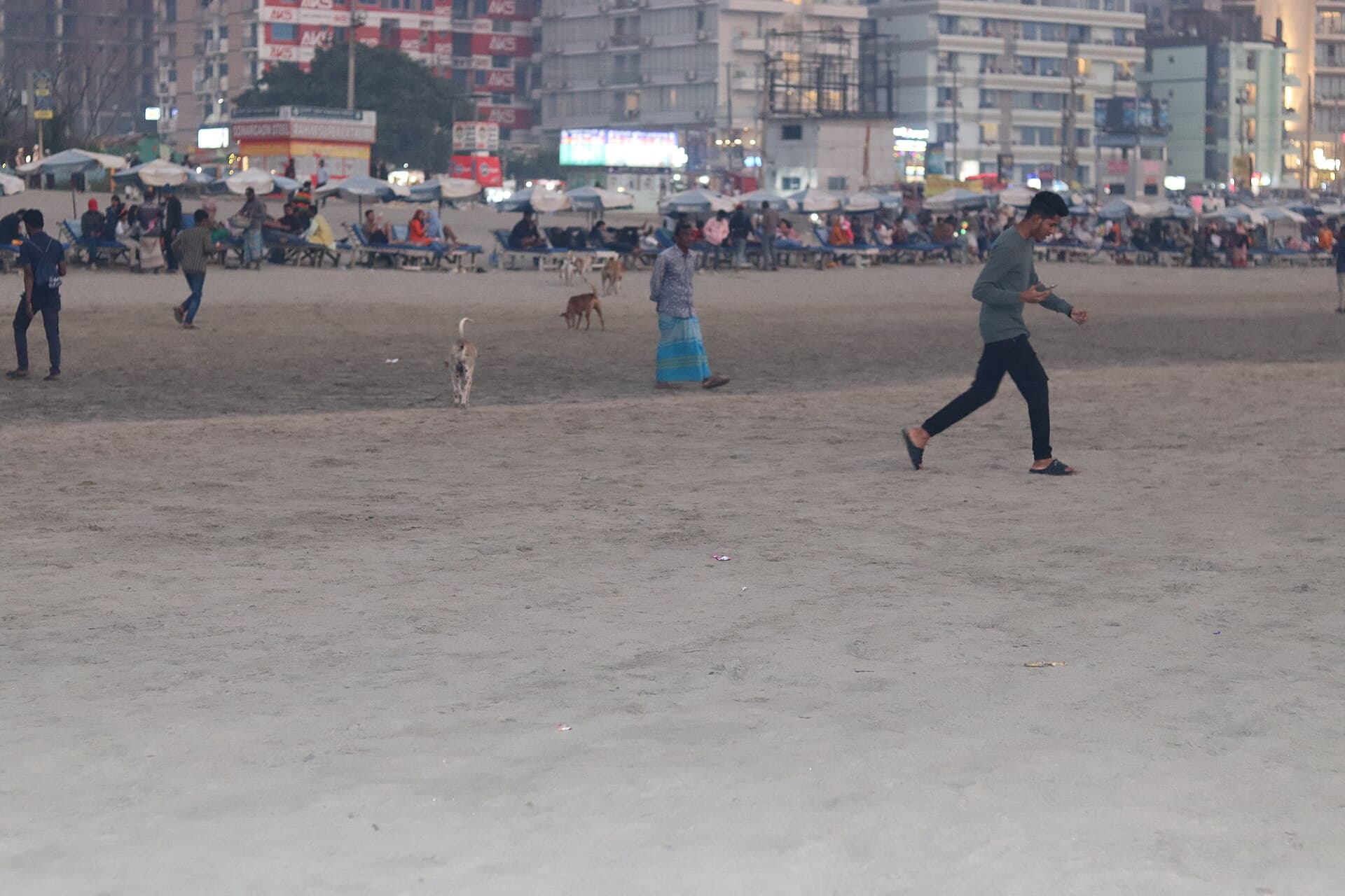 Wide view of Cox's Bazar sea beach with visitors along the shoreline